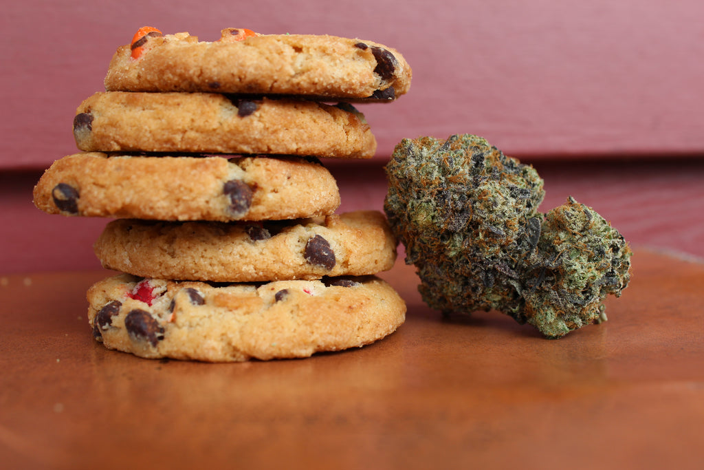 Cannabis flower next to a stack of edibles cookies